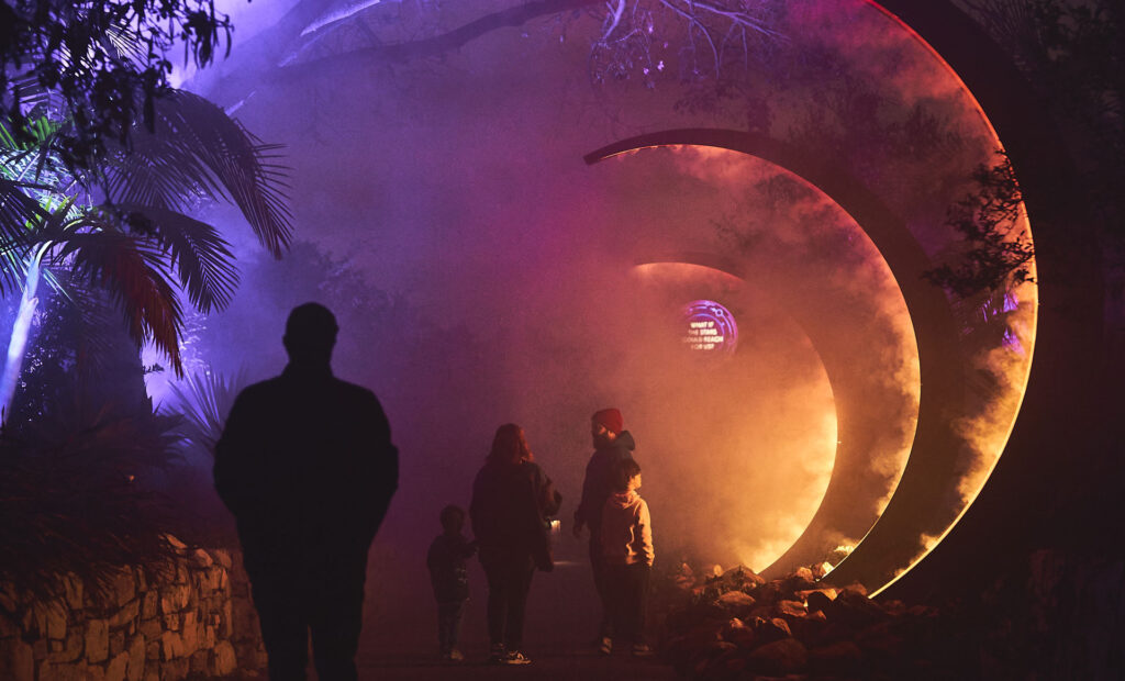 People walk under the Archway at Astra Lumina